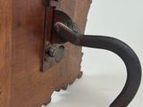 a wooden box with a handle and a rock on it