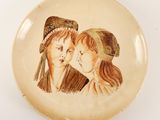 an image of a plate with a picture of two women on it