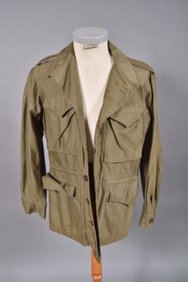 une veste militaire vert olive posée sur un mannequin