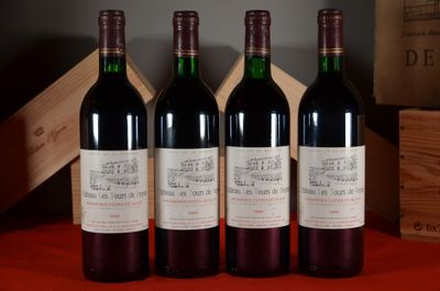 three bottles of red wine sitting on a table next to a wooden box