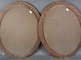 pair of antique wooden oval mirrors with brass rims
