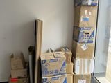 a stack of boxes sitting on the floor next to a window