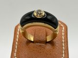 a close up of a gold ring with a black stone on it