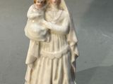 une figurine représentant une femme tenant un bébé dans ses bras