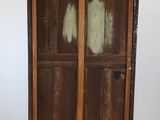a wooden cabinet that has been painted brown and is on wheels
