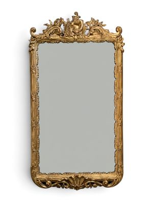 an image of a gold framed mirror on a white wall