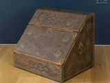 an old wooden box sitting on top of a wooden floor next to a blue wall
