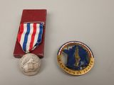 two medals are placed next to each other on a table