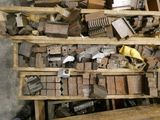 a pile of old typewriters on a wooden shelf