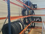 a large rack of tires in a warehouse with shelves full of tires