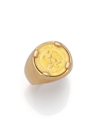 a gold ring with a coin in the middle of it