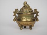an antique brass incense pot with a lid and handles