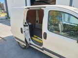 a white van that is parked in front of a building