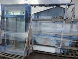 many pallets of glass on a pallet in a warehouse