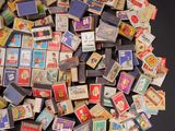 a pile of matchboxes on a table with a black background