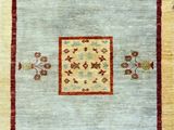 a beige and red rug with a square design on it