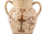 a vase that is sitting on a white surface