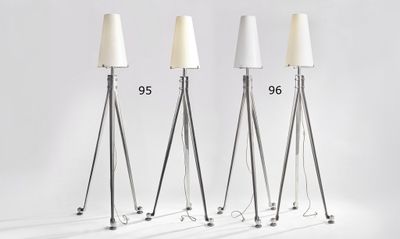 three floor lamps with a white shade on each of them