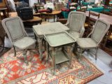 several chairs and a table in a room with a rug on the floor