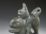 statue of a fish holding a bird on its back