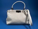 a white handbag on a blue background