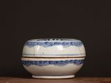 a blue and white bowl sitting on a wooden table