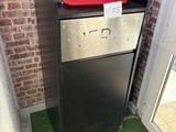 an image of a refrigerator in a room with a brick wall in the background