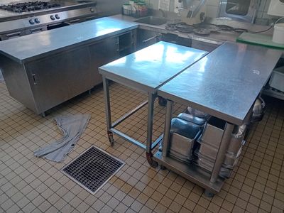a large kitchen with a lot of stainless steel counter tops