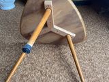 a small wooden table with a wooden stick on it