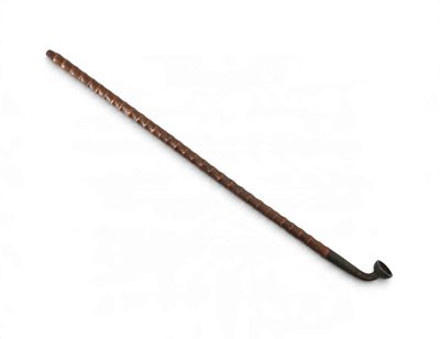 a close up of a wooden stick on a white surface