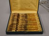 a lot of forks and spoons in a case