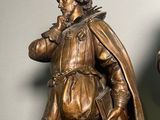 two bronze statues of a man and a woman standing next to each other