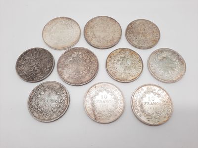 a group of silver coins on a white surface