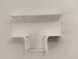 a white shelf on the wall above a toilet
