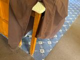 a brown pants sitting on a stool in a room