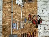 many tools hanging on the wall in this garage