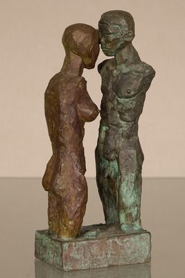 statue of a man and a woman standing next to each other on a table