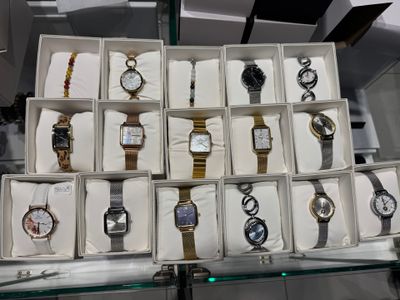 many watches in a display case on the table