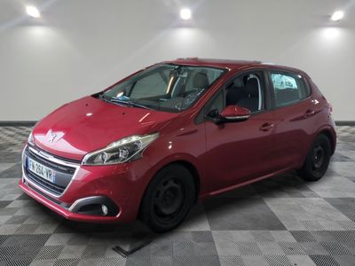the red car is parked on a checkered floor in the garage