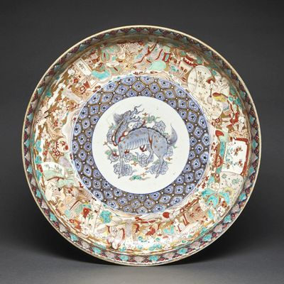 an image of a plate with a dragon on it on a black background