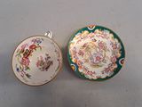 two cups and saucers are sitting side by side on a table