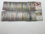 a bunch of pokemon cards sitting on top of each other