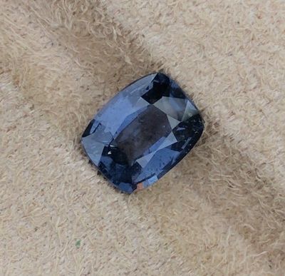 un gros plan d'un saphir bleu posé sur un morceau de tissu