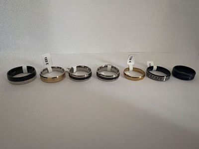 four different types of rings are shown on a white surface