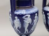 pair of blue and white vases sitting on top of a table