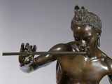 bronze statue of a man holding a sword in his right hand