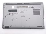 a broken laptop computer sitting on a white surface