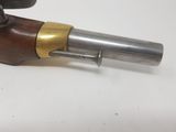 a close up of a gun on a table with a white background