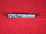 a close up of a red sweater with the word rochebools printed on it