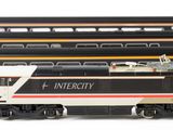 several model trains are lined up next to each other on a white surface